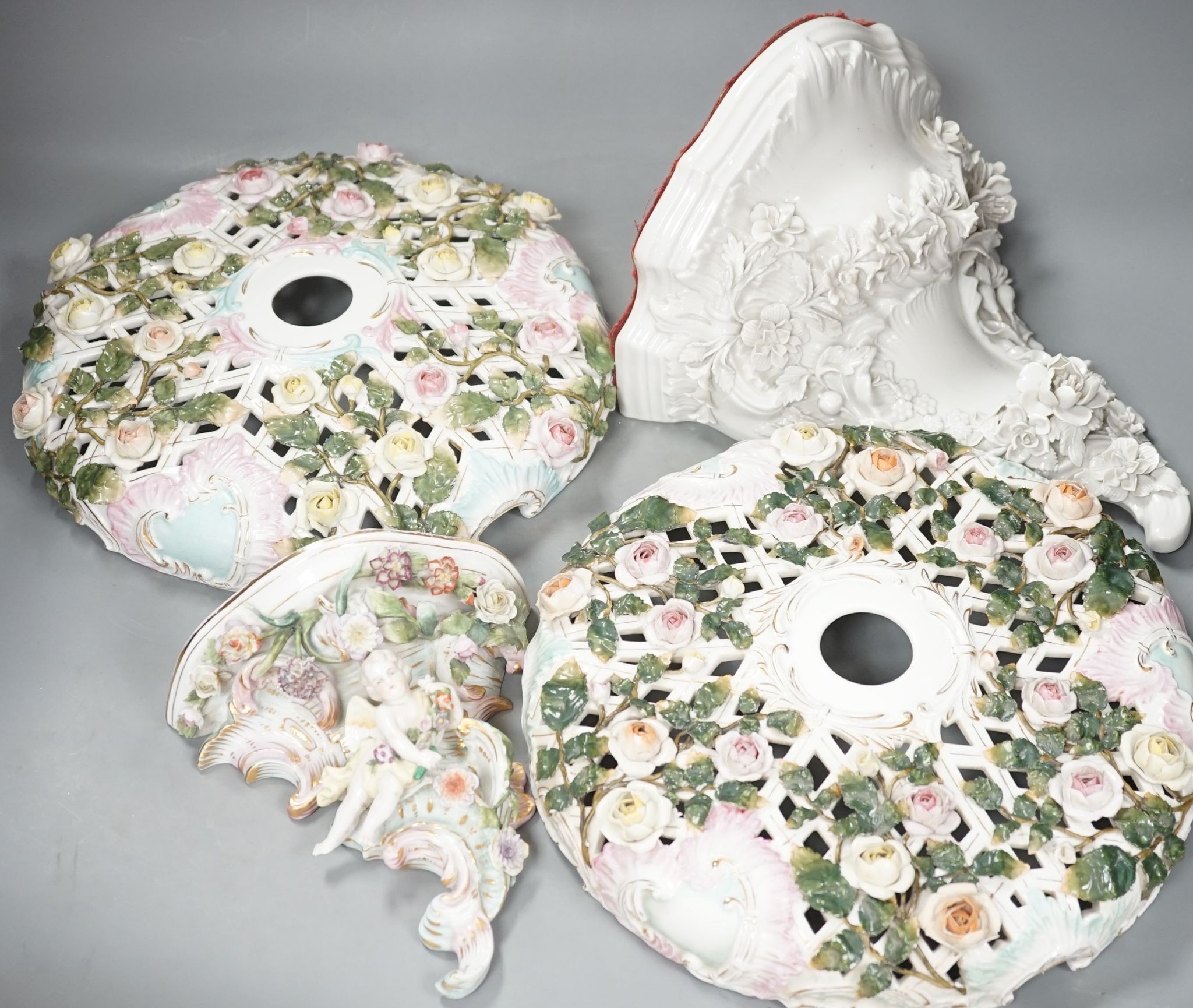 Two Sitzendorf porcelain ceiling shades, a similar wall bracket and a Dresden white glazed wall bracket, shades 30cm diameter